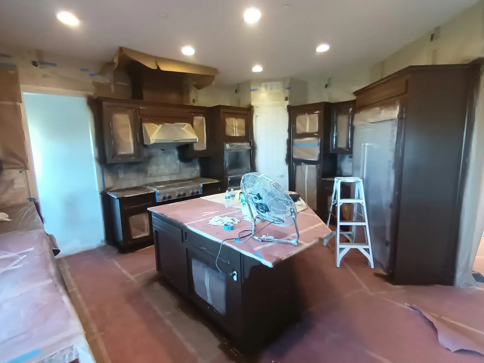 Cabinet refinishing in San Jose, CA: kitchen with dark cabinets and covered island