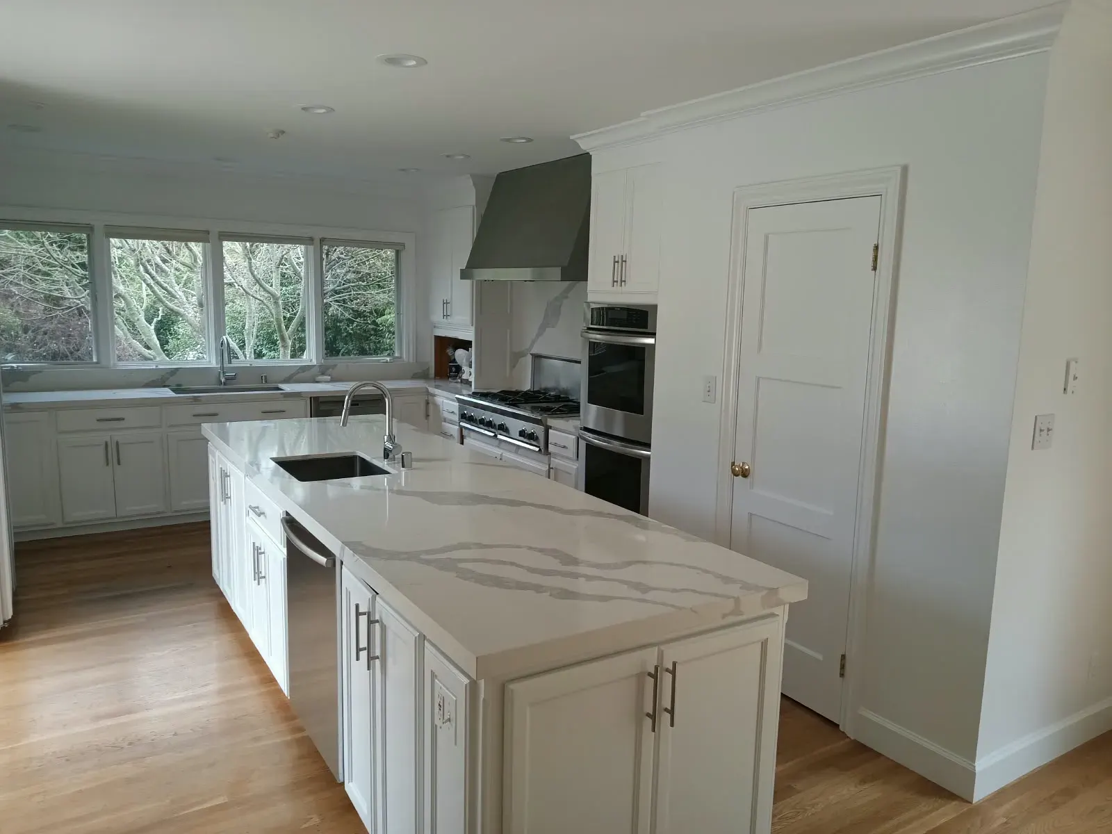 Painting services in San Jose, CA: white kitchen with painted cabinets, walls and trim