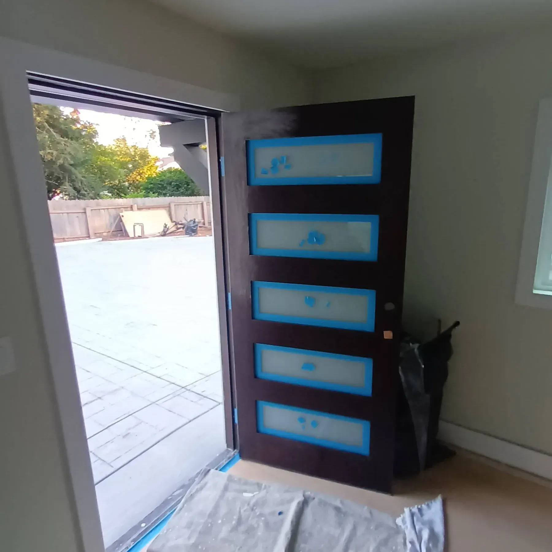 Door painting in San Jose, CA: five-panel door with glass lites taped off