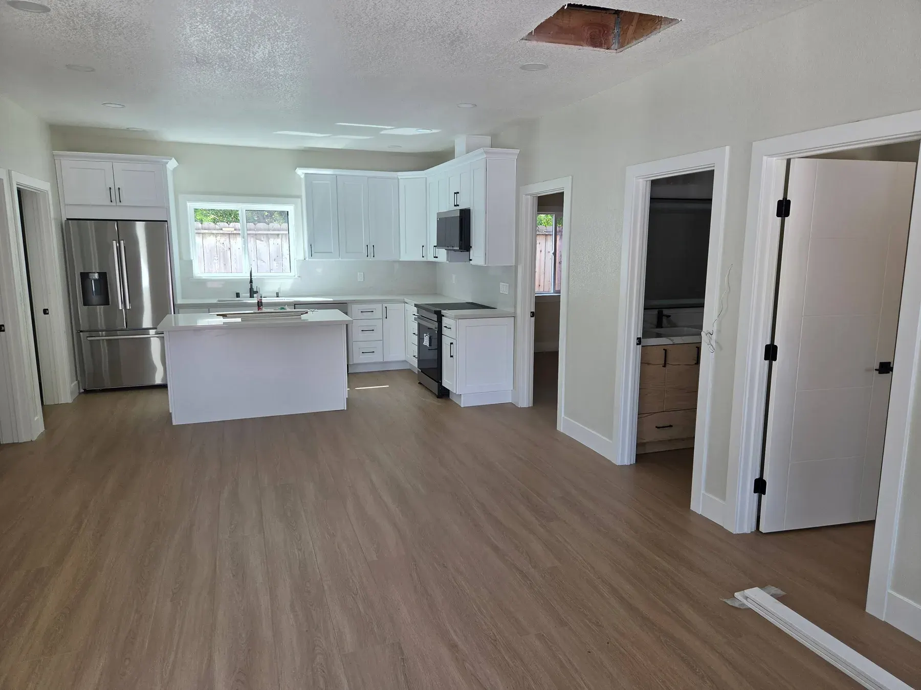 Interior painting in San Jose, CA: white trim, doors and walls in a remodeled kitchen