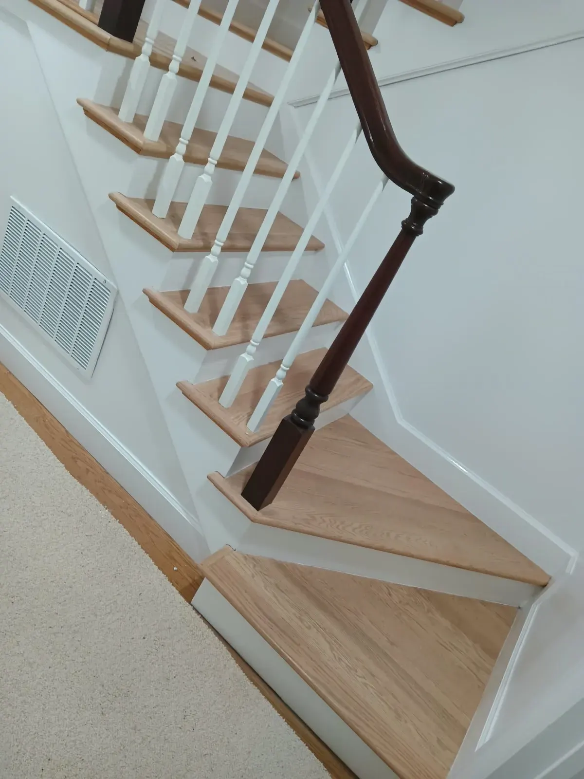Staircase painting in San Jose, CA: white balusters and stained handrail