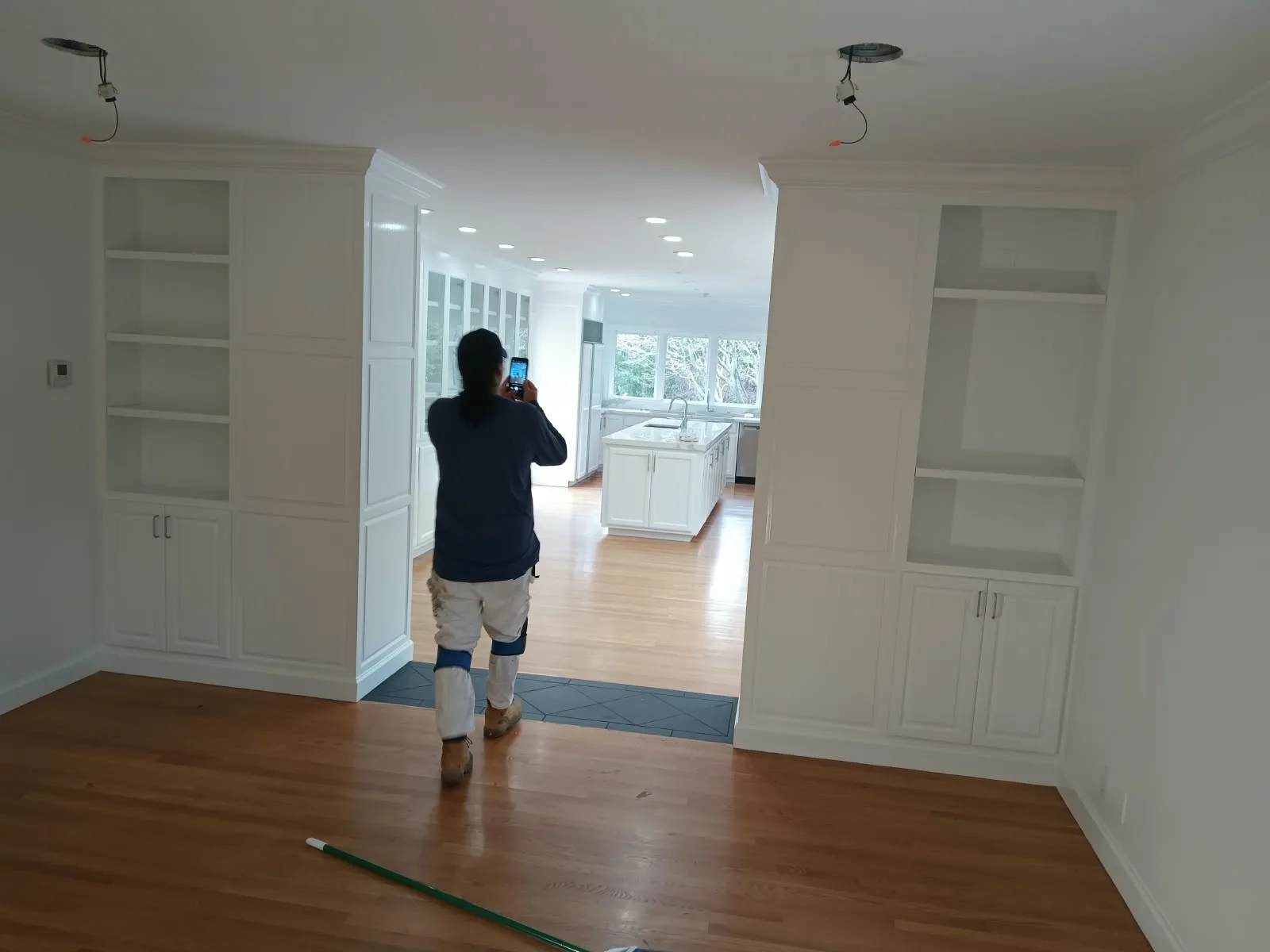 Interior painting in San Jose, CA: painter inspecting freshly painted built-ins