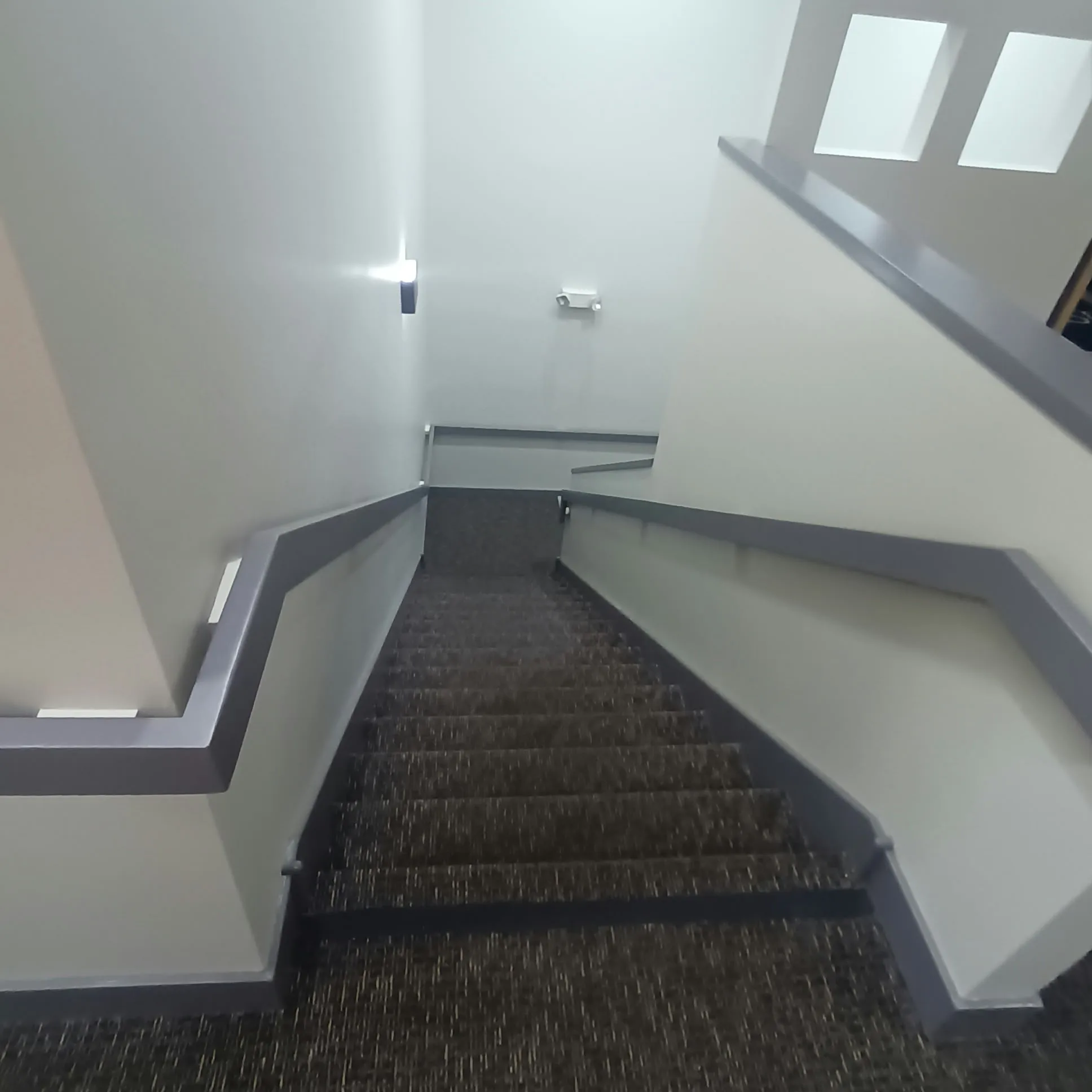 Staircase painting in San Jose, CA: stairwell with painted gray rail and walls