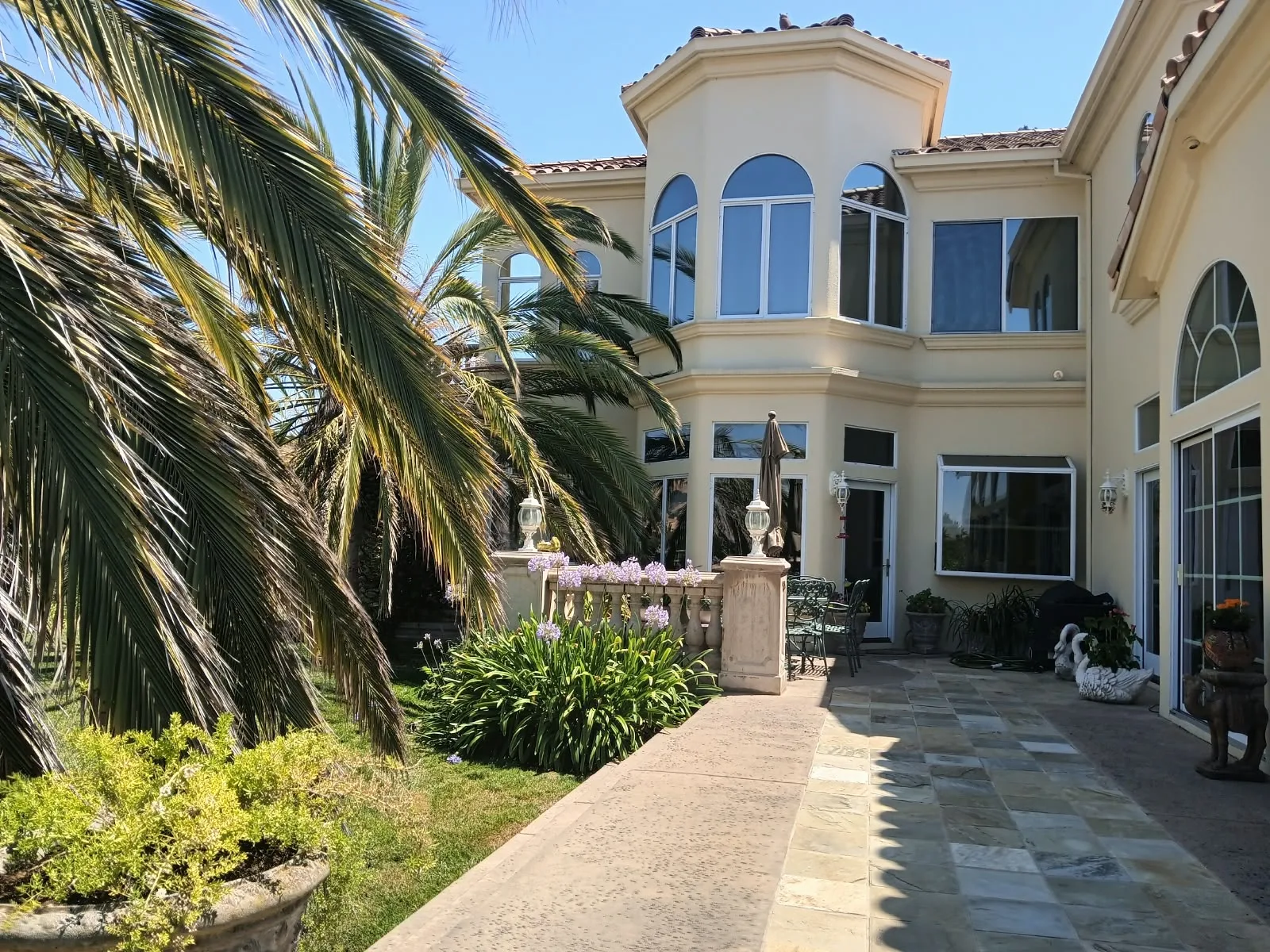 Exterior painting in San Jose, CA: two-story stucco home with arched windows