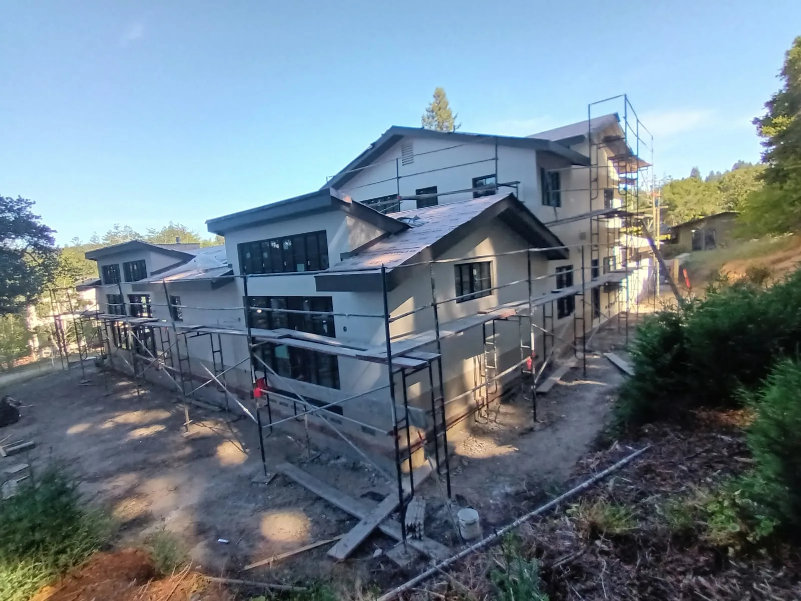 Exterior painting in San Jose, CA: two-story home with scaffolding set up for painting